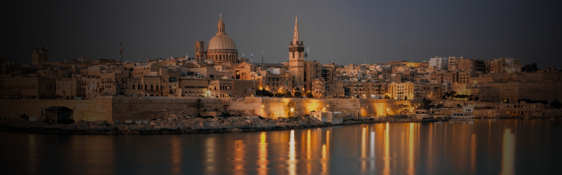 Historic cityscape with illuminated buildings.